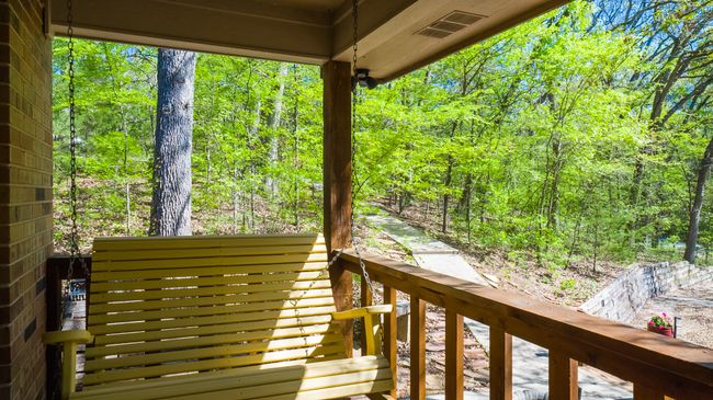 Wooden deck with a wooded view and visible vents | Image 26