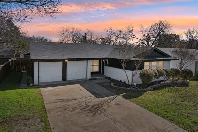 View of front of home featuring a garage, concrete driveway, and a shingled roof | Image 30