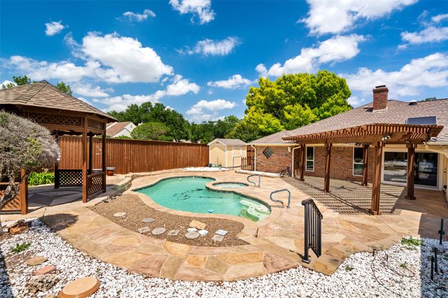 View of swimming pool featuring a pergola, a fenced backyard, and a patio | Image 4