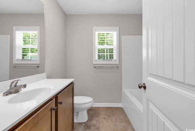 Bathroom featuring vanity, toilet, baseboards, and a bathtub | Image 17