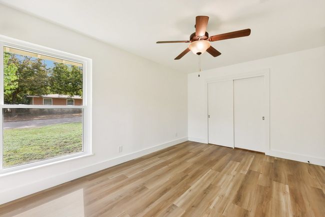 Unfurnished bedroom with a closet, light wood-style flooring, baseboards, and ceiling fan | Image 18