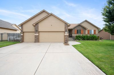 View of front facade with a garage and a front yard | Image 2