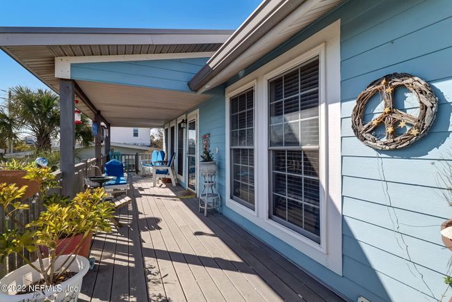 Unit A's large porch area with views of the ocean. | Image 14