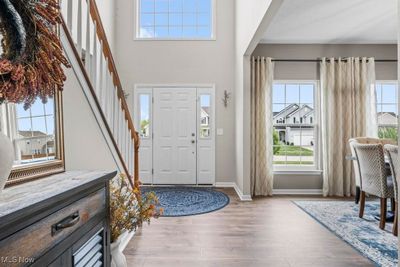 Foyer entrance featuring hardwood / wood-style floors and a wealth of natural light | Image 3