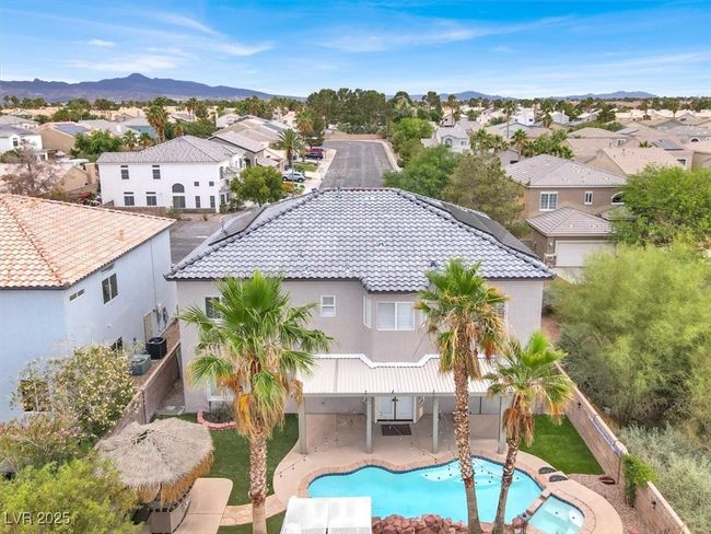 Aerial perspective of suburban area with a pool and a mountain backdrop | Image 49