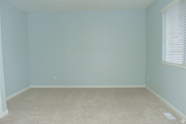 Spare room with baseboards and light colored carpet | Image 10