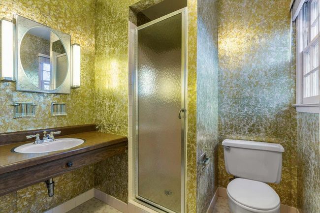 Full bathroom with wallpapered walls, a wealth of natural light, and a sink | Image 19