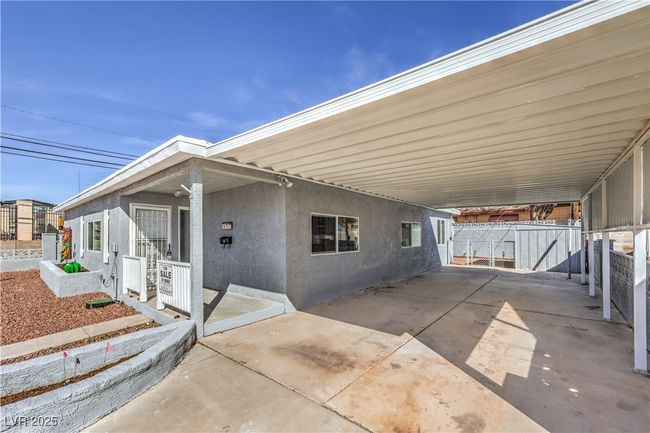 View of patio / terrace with an attached carport, fence, and driveway | Image 4