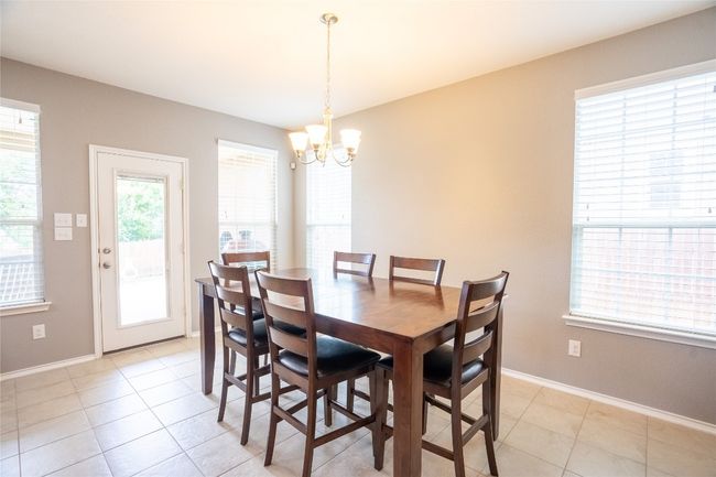 Dining area featuring a chandelier and light tile patterned flooring | Image 12