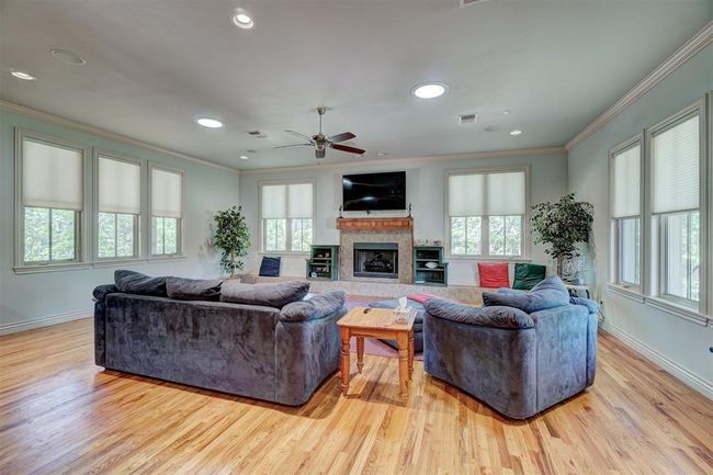 Living room featuring wood finished floors, a wealth of natural light, and crown molding | Image 6