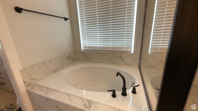 Bathroom featuring a bath | Image 15