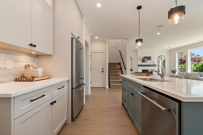 Kitchen with stainless steel appliances, open floor plan, recessed lighting, backsplash, and light wood-style floors | Image 4
