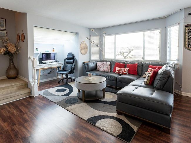 Living area with baseboards and wood finished floors | Image 13