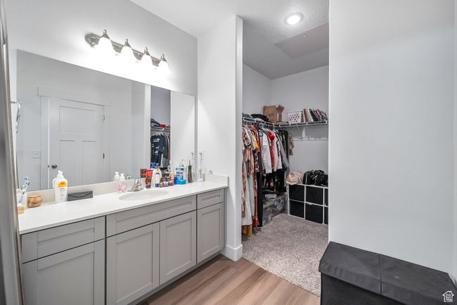 Bathroom with recessed lighting, wood finished floors, a spacious closet, and vanity | Image 11
