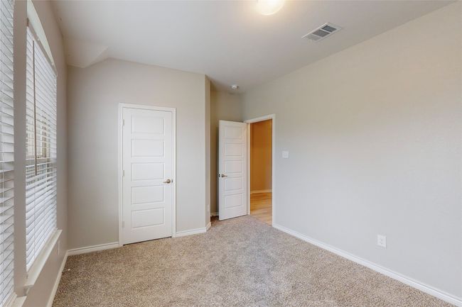 Unfurnished bedroom with visible vents, baseboards, and carpet floors | Image 23