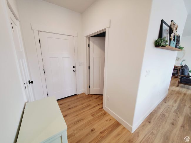 Corridor featuring light wood-style flooring and baseboards | Image 7