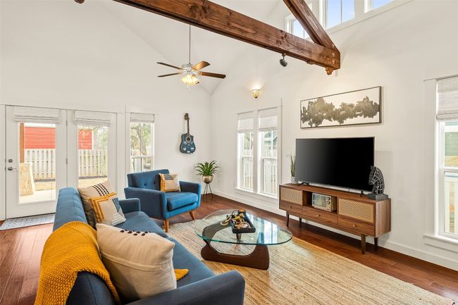 Living area featuring high vaulted ceiling, wood-type flooring, ceiling fan, and beamed ceiling | Image 8