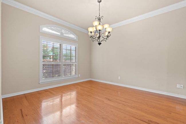 Dining room with a chandelier, ornamental molding, and light wood-type flooring | Image 9