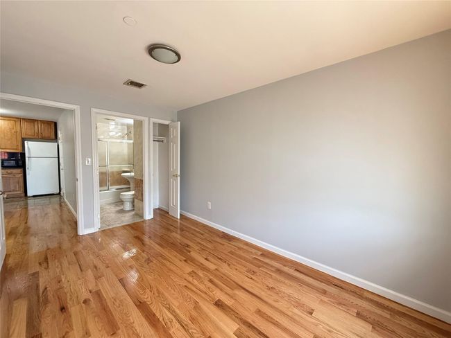 Unfurnished room featuring baseboards and light wood-style floors | Image 5