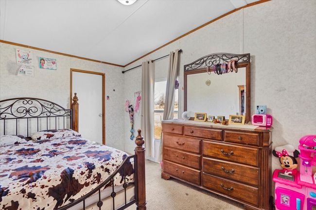 Bedroom featuring ornamental molding, vaulted ceiling, and light colored carpet | Image 18