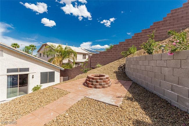 View of yard with from raised patio & fire pit. | Image 32