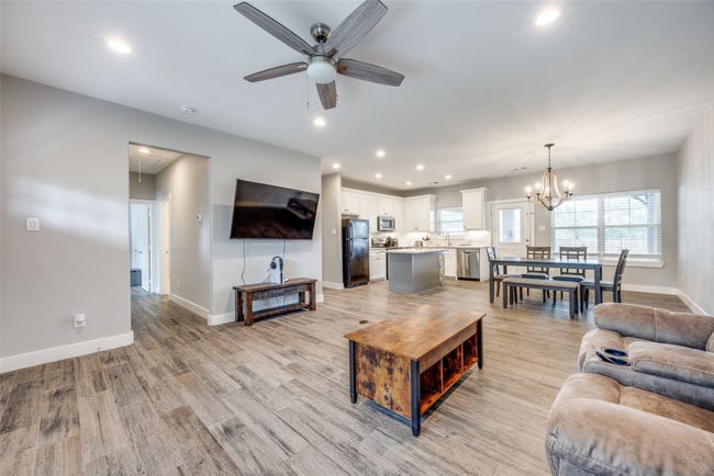Living area featuring attic access, ceiling fan, baseboards, recessed lighting, and light wood-type flooring | Image 5