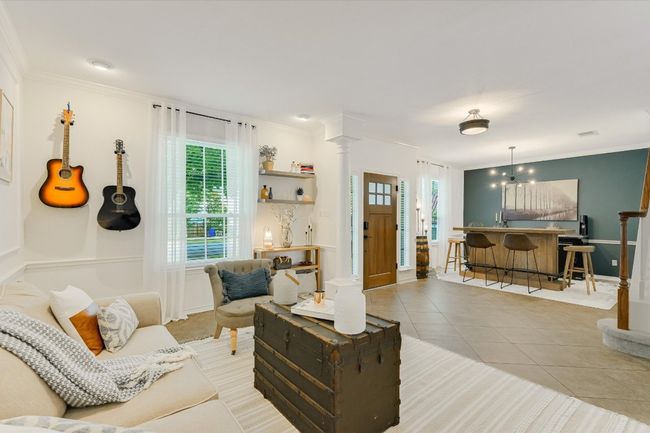 Living room featuring ornate columns, ornamental molding, and light tile patterned floors | Image 4