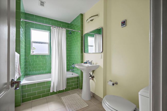Full bath with tiled shower / bath combo, toilet, visible vents, and tile patterned flooring | Image 22