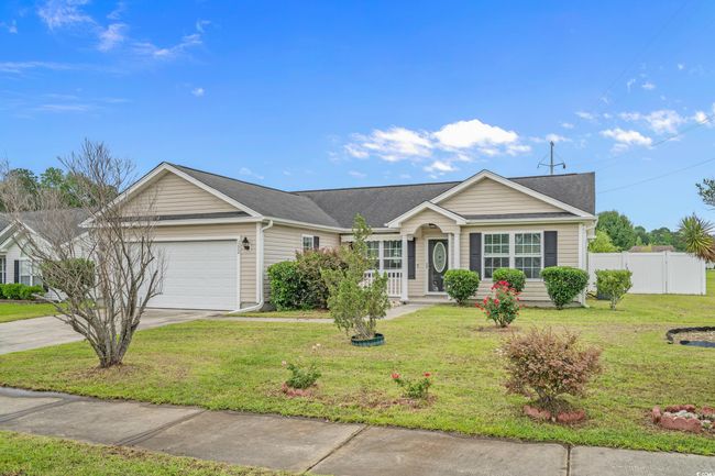 Ranch-style house with an attached garage, driveway, and a shingled roof | Image 38