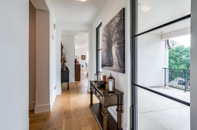Hallway to kitchen with view of balcony | Image 18