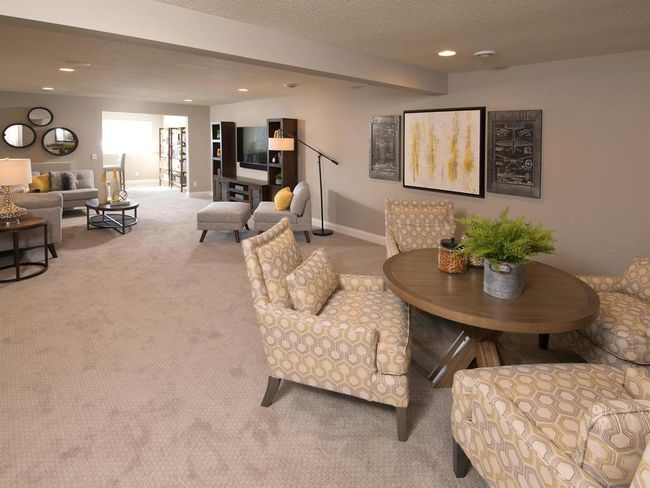 Finished Lower Level with Family room, sitting room & Wet Bar w/fridge. Plus 2 more bedrooms & bathroom. Photos may not depict actual home plan configuration. Features/materials/finishes shown contain options that are not included in price. | Image 17