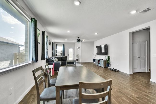 Dining area with baseboards, recessed lighting, wood finished floors, a ceiling fan, and a textured ceiling | Image 10