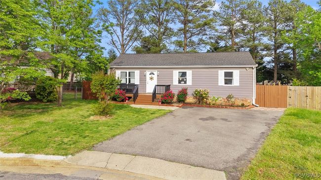 Bungalow-style home featuring fence, a gate, driveway, and a front yard | Image 4