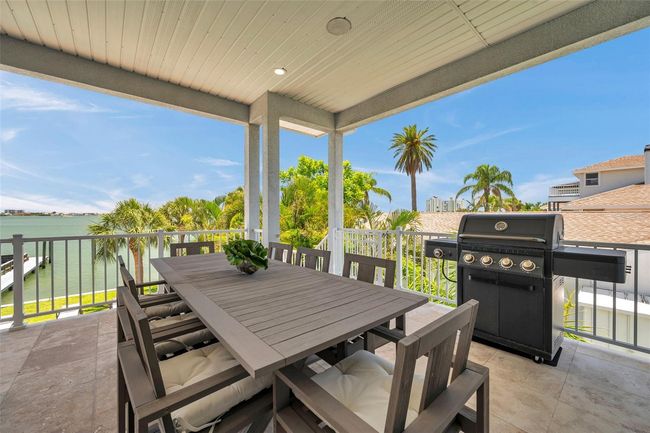 Huge covered 2nd story balcony with travertine tile. | Image 16