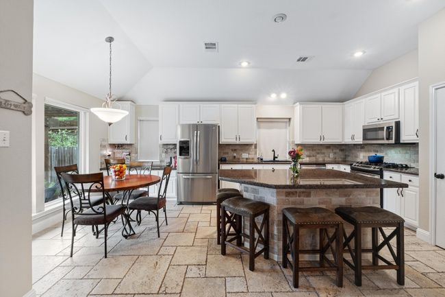 Open kitchen with stainless steel appliances, and view of pool | Image 10