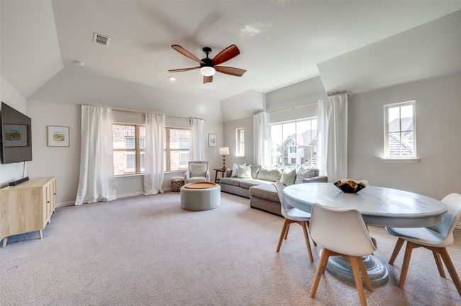 Upstairs game room is spacious and has several areas for secondary living space, craft room, game room or play area. Taller ceilings and upgraded lighted ceiling fan adds to this space. | Image 25