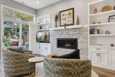 Relax with a book in front of the stone surround gas fireplace | Image 3