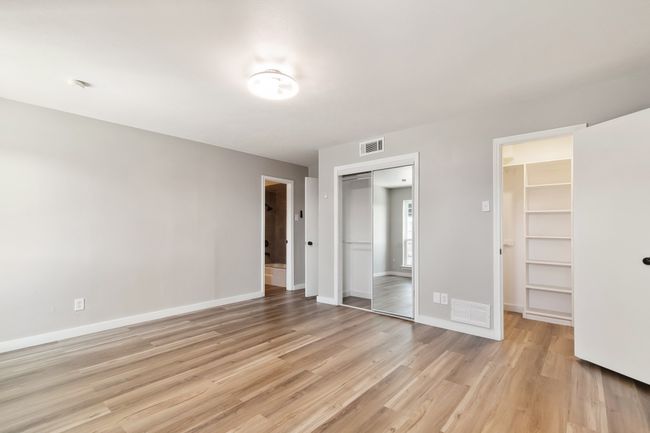 Unfurnished bedroom featuring baseboards, visible vents, and light wood finished floors | Image 25