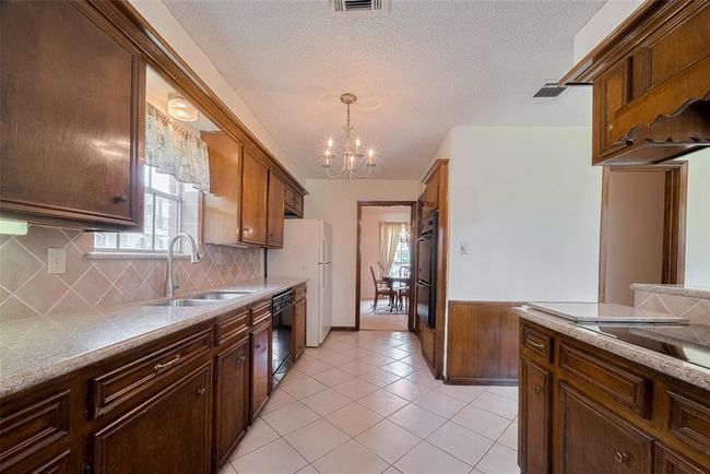 This kitchen boasts a convenient double oven and a spacious pantry nearby. | Image 11
