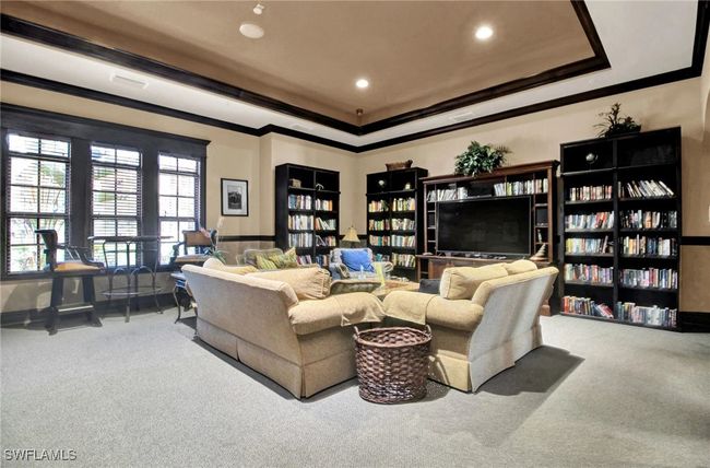 Living room with carpet, crown molding, a raised ceiling, and recessed lighting | Image 43
