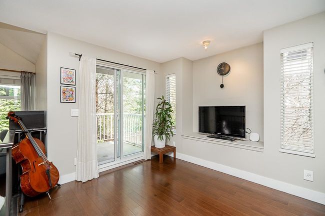 Living room featuring baseboards, dark wood finished floors, and plenty of natural light | Image 11