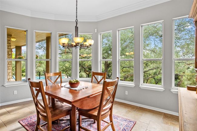 The eat in kitchen area takes advantage of the beautiful trees and views | Image 13