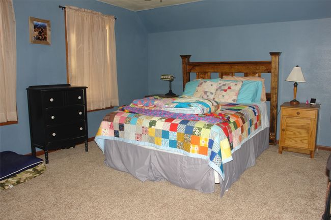 Carpeted bedroom featuring vaulted ceiling | Image 12