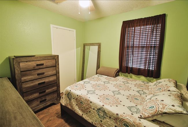 Bedroom featuring a ceiling fan and a textured ceiling | Image 10