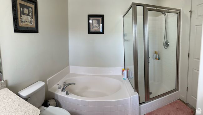 Full bath featuring toilet, vanity, a shower stall, and a bath | Image 26