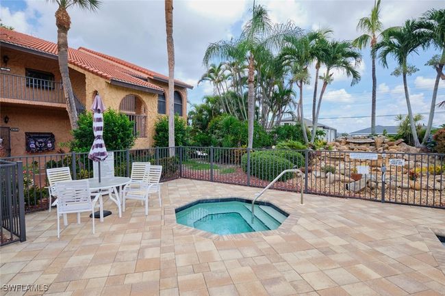 View of swimming pool with a hot tub and a patio area | Image 37