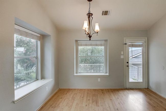 Unfurnished dining area with light wood-type flooring, healthy amount of natural light, and baseboards | Image 26