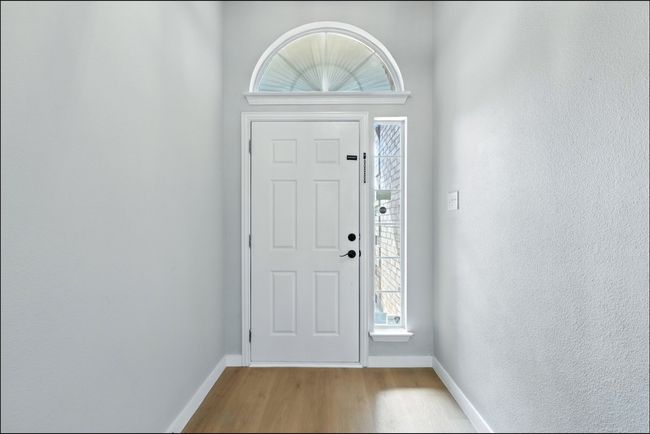 Foyer entrance featuring wood finished floors and baseboards | Image 5
