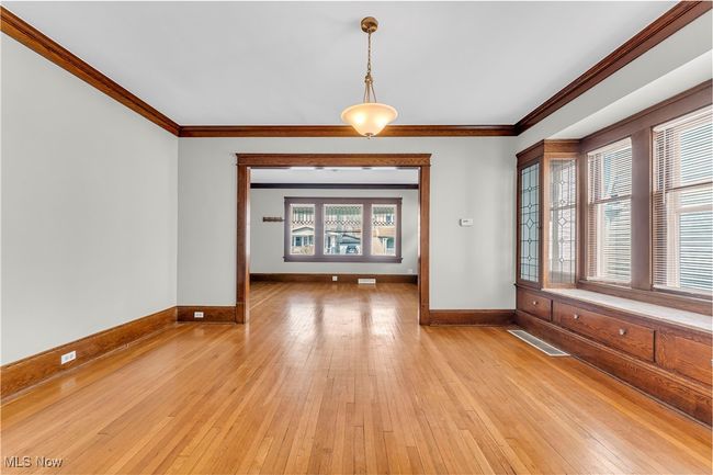 Spare room with visible vents, light wood-type flooring, ornamental molding, and baseboards | Image 10