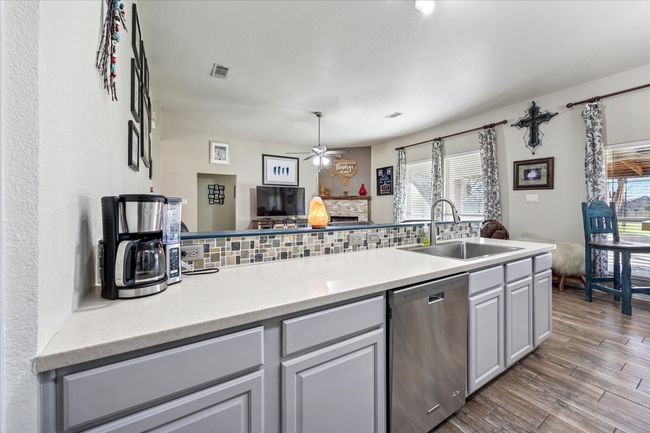 Open-concept kitchen seamlessly flowing into the living area, perfect for entertaining and everyday convenience. | Image 10